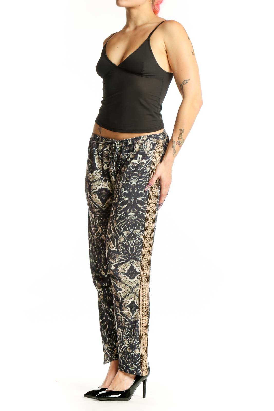 Black and cream floral print modal pants with gold metallic side trim, front view on model