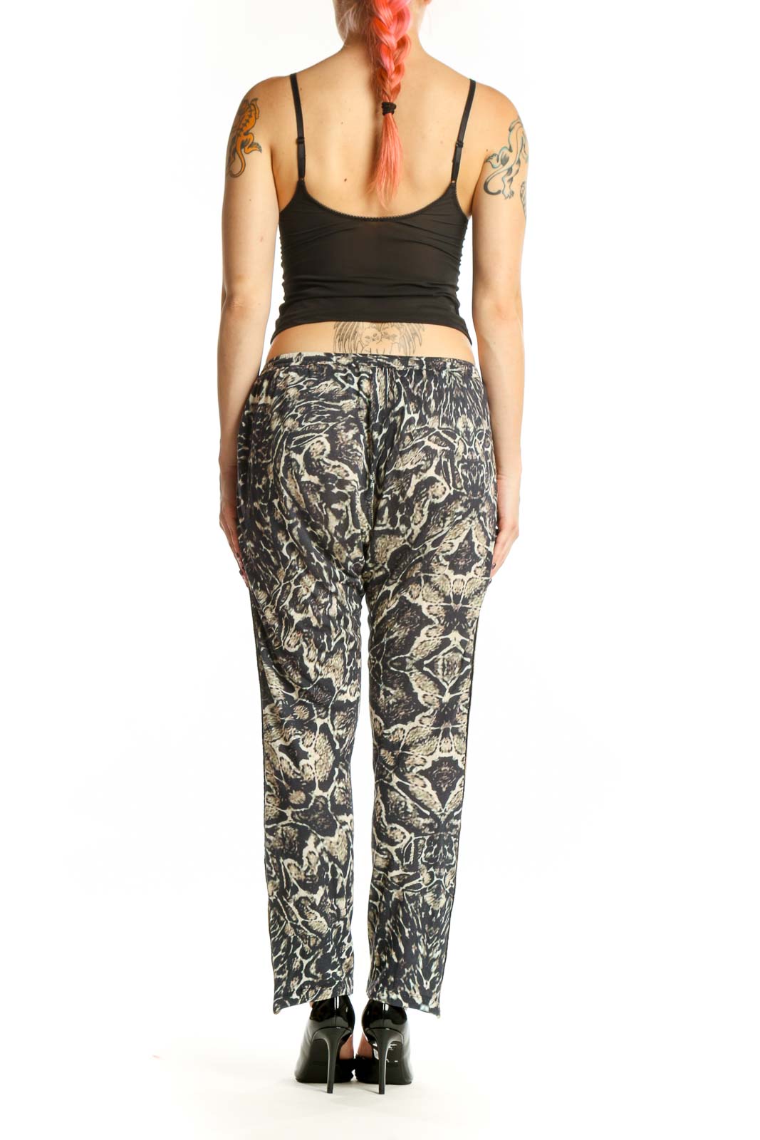 Black and cream botanical floral print modal pants with gold metallic trim, back view on model
