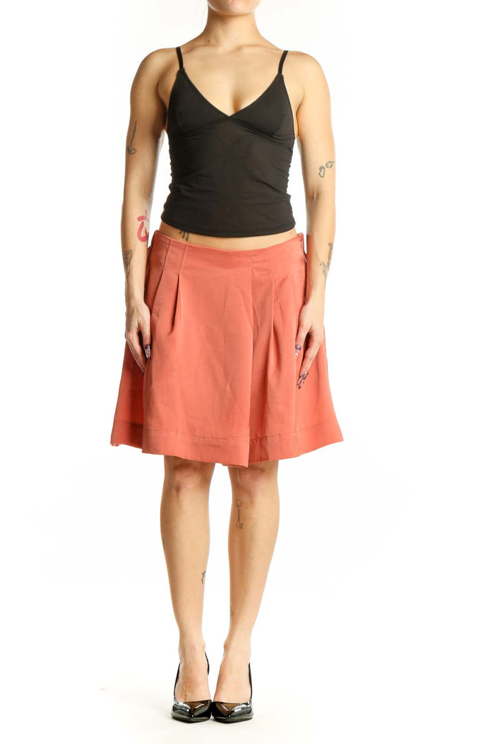 Coral pleated knee-length shorts from Banana Republic, front view showing waist pleating and solid color design