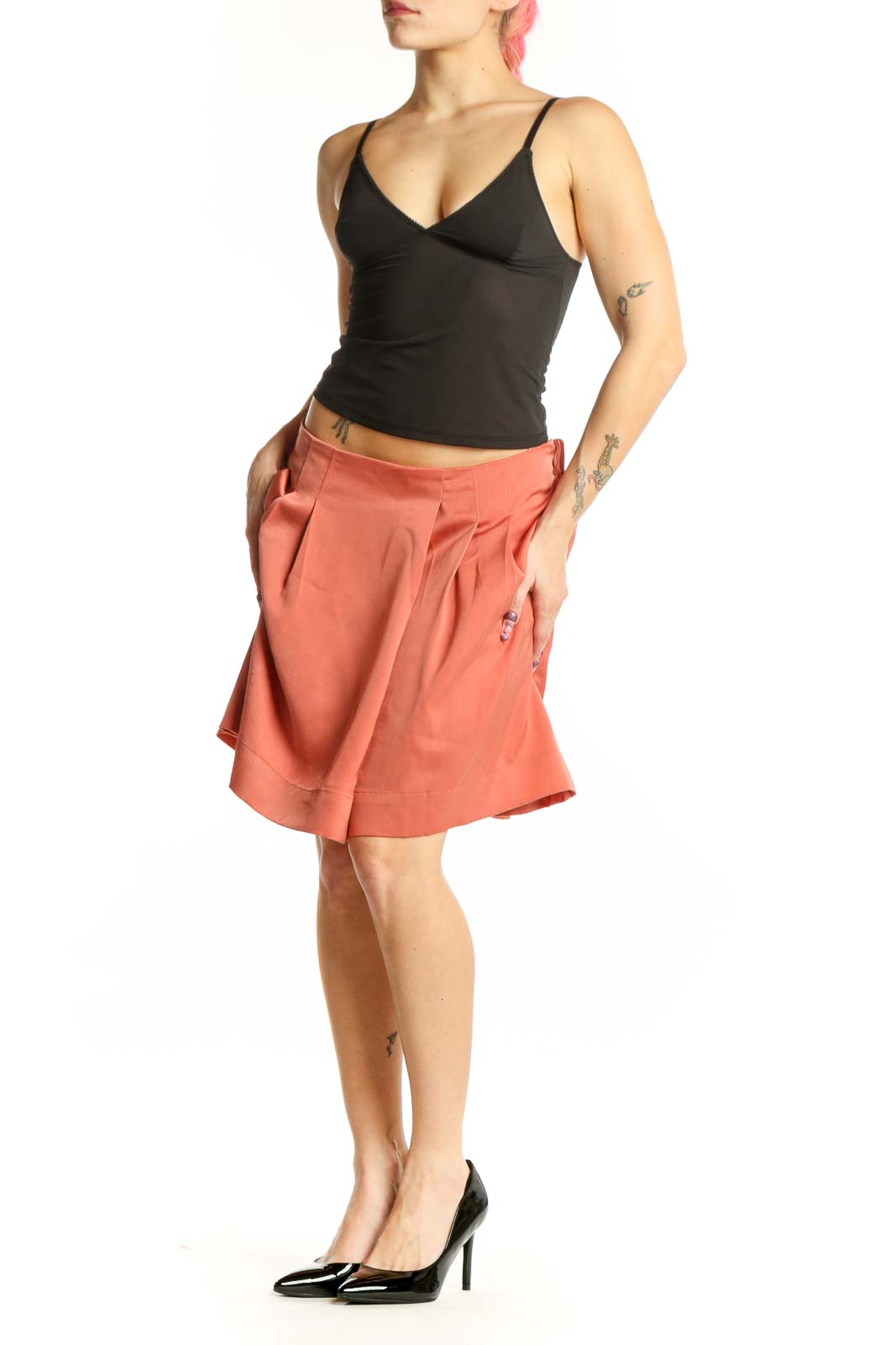 Coral pleated knee-length shorts from Banana Republic, front view showing waist pleating and solid color design