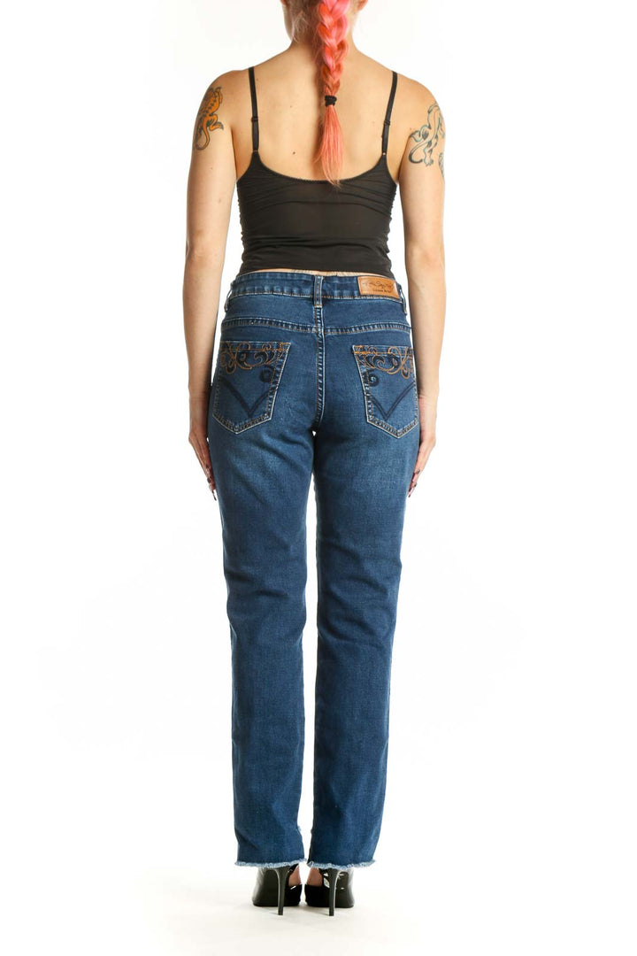 Back view of blue denim straight-leg jeans with side slit detail by Suzanne Betro