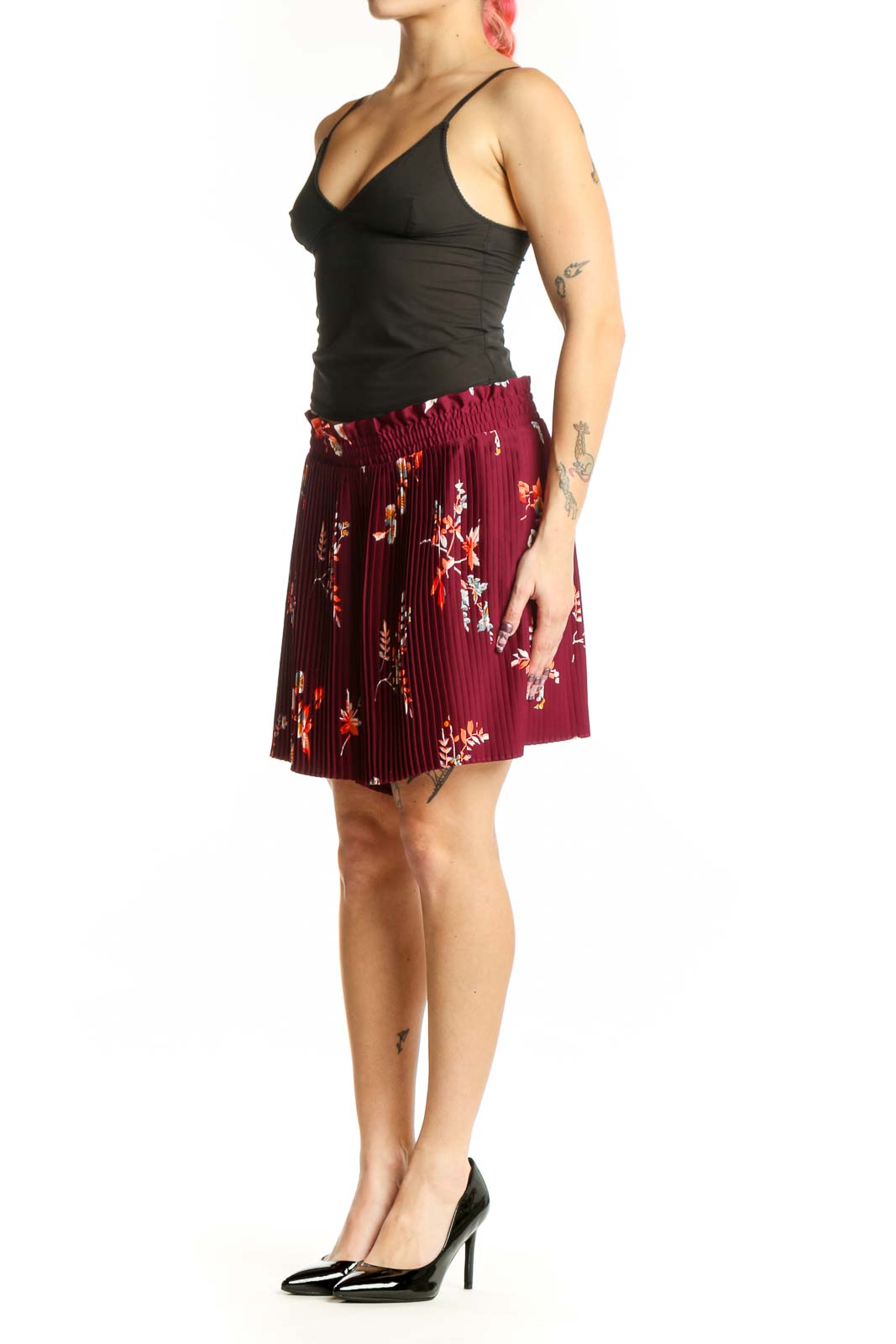 Front view of burgundy floral pleated shorts with orange and yellow botanical print, elastic waistband, and knee-length cut