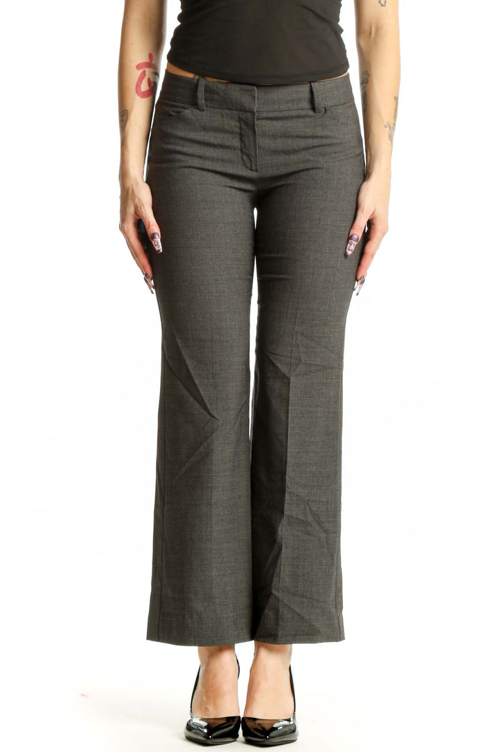 Front view of gray Theory dress pants with tailored flat-front design and mid-rise waist on model wearing black top