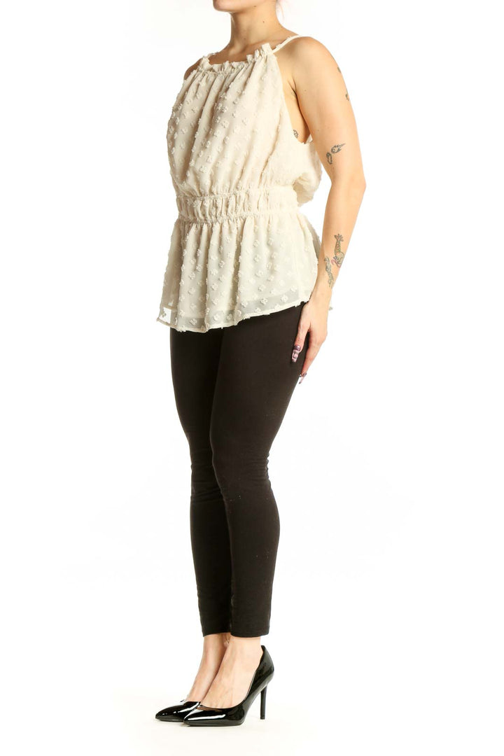 Cream beaded sleeveless blouse with off-shoulder neckline and cinched waist, front view