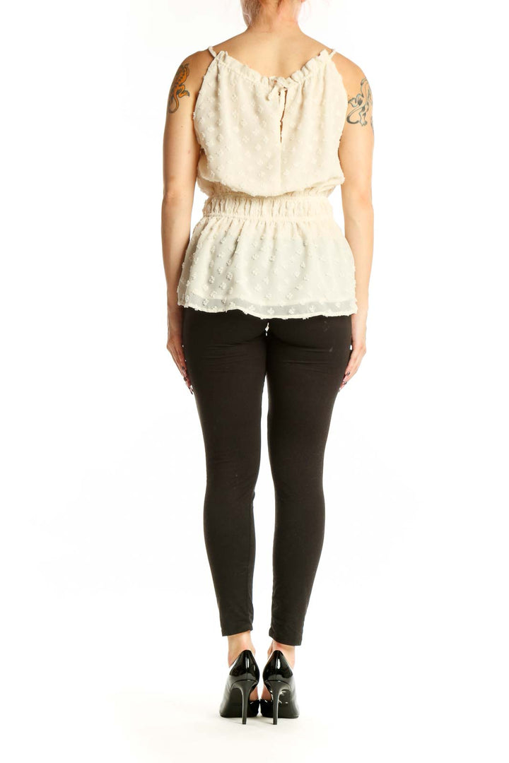 Cream beaded sleeveless blouse with ruched details, back view