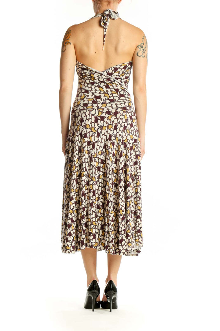 Brown floral halter midi dress with A-line silhouette and flowing skirt, back view