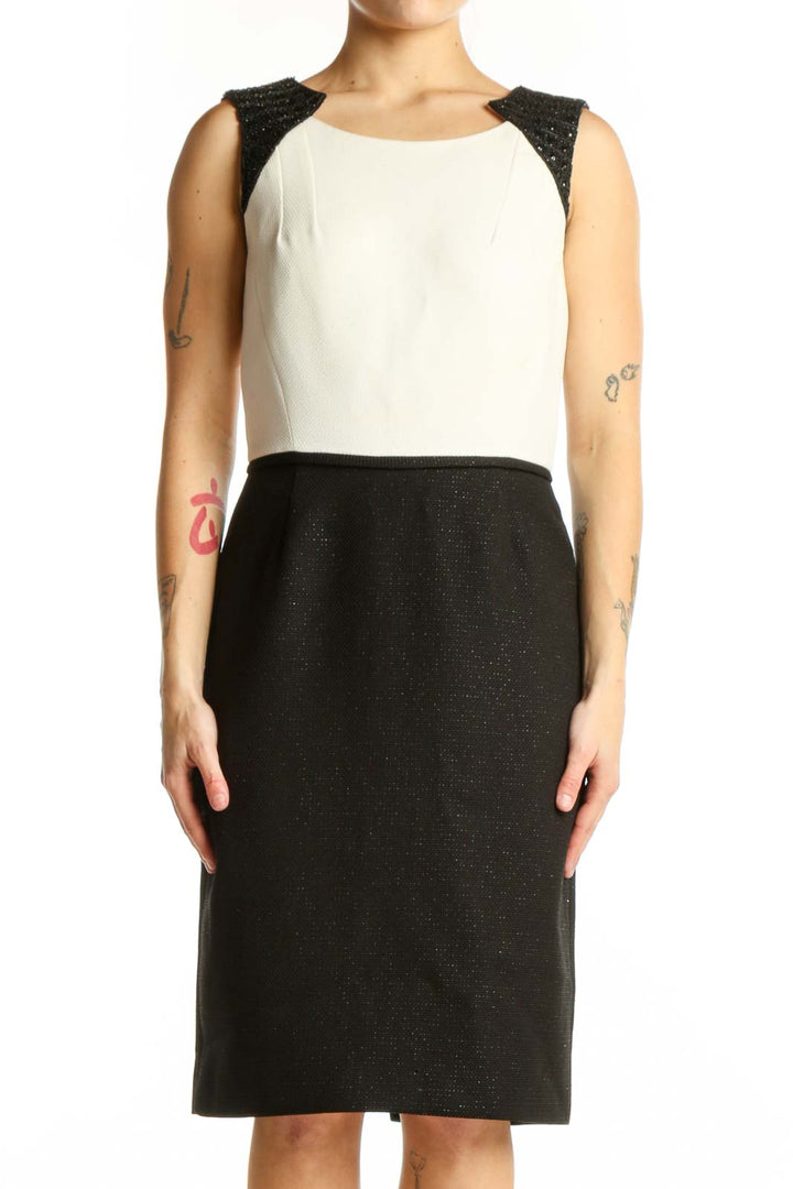 Black and cream Tahari color block sheath dress with sparkly black shoulder panels, front view