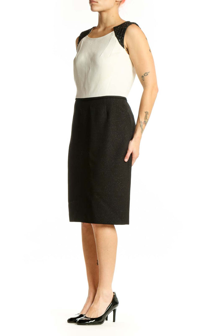 Black and cream Tahari color block sheath dress with sparkly black shoulder panels, front view