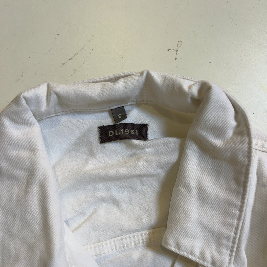 Tag view of white cropped denim jacket showing frayed hem detail and classic denim construction