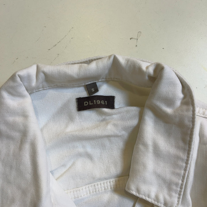 Tag view of white cropped denim jacket showing frayed hem detail and classic denim construction