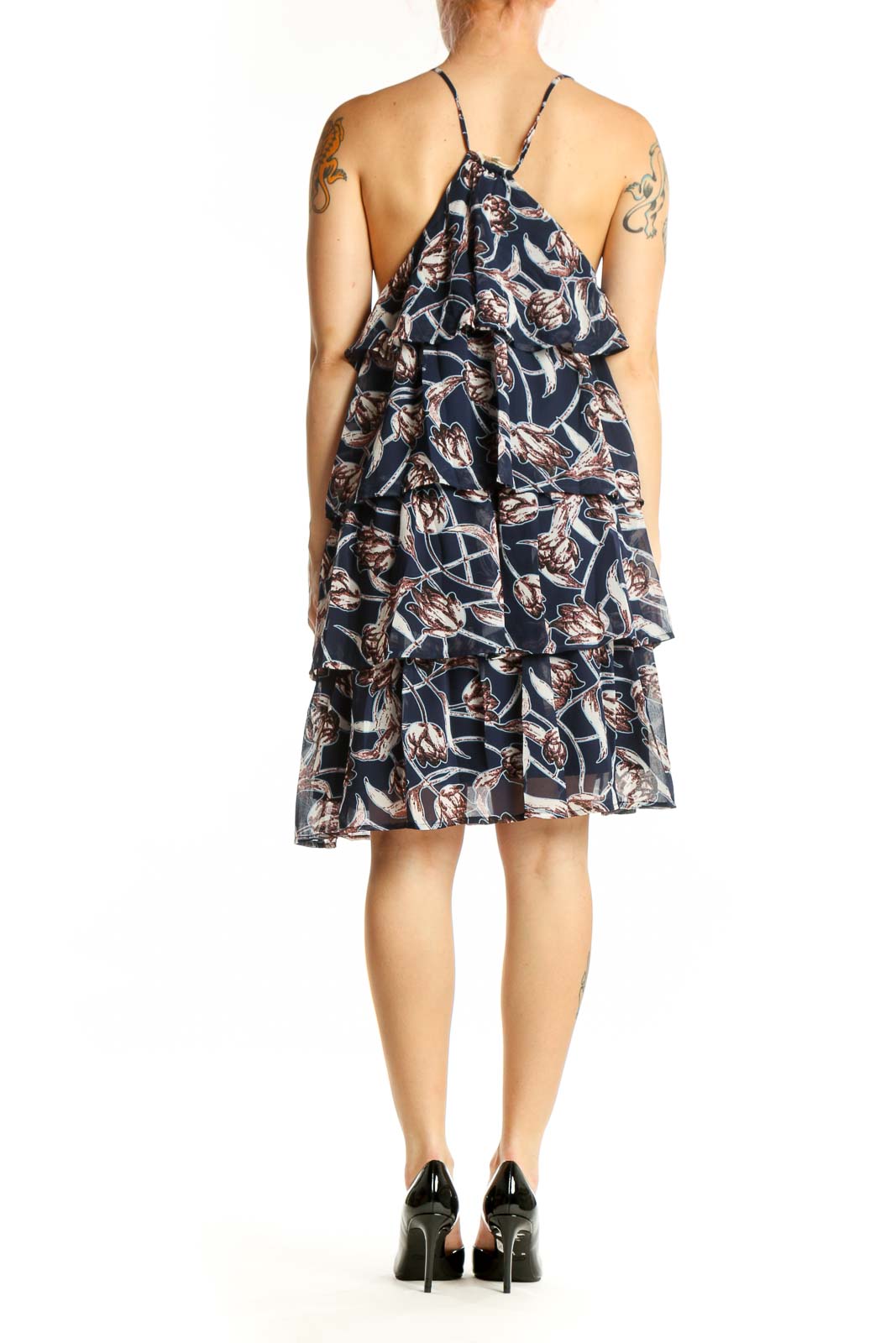 Back view of navy floral halter dress showing open back design and ruffle details