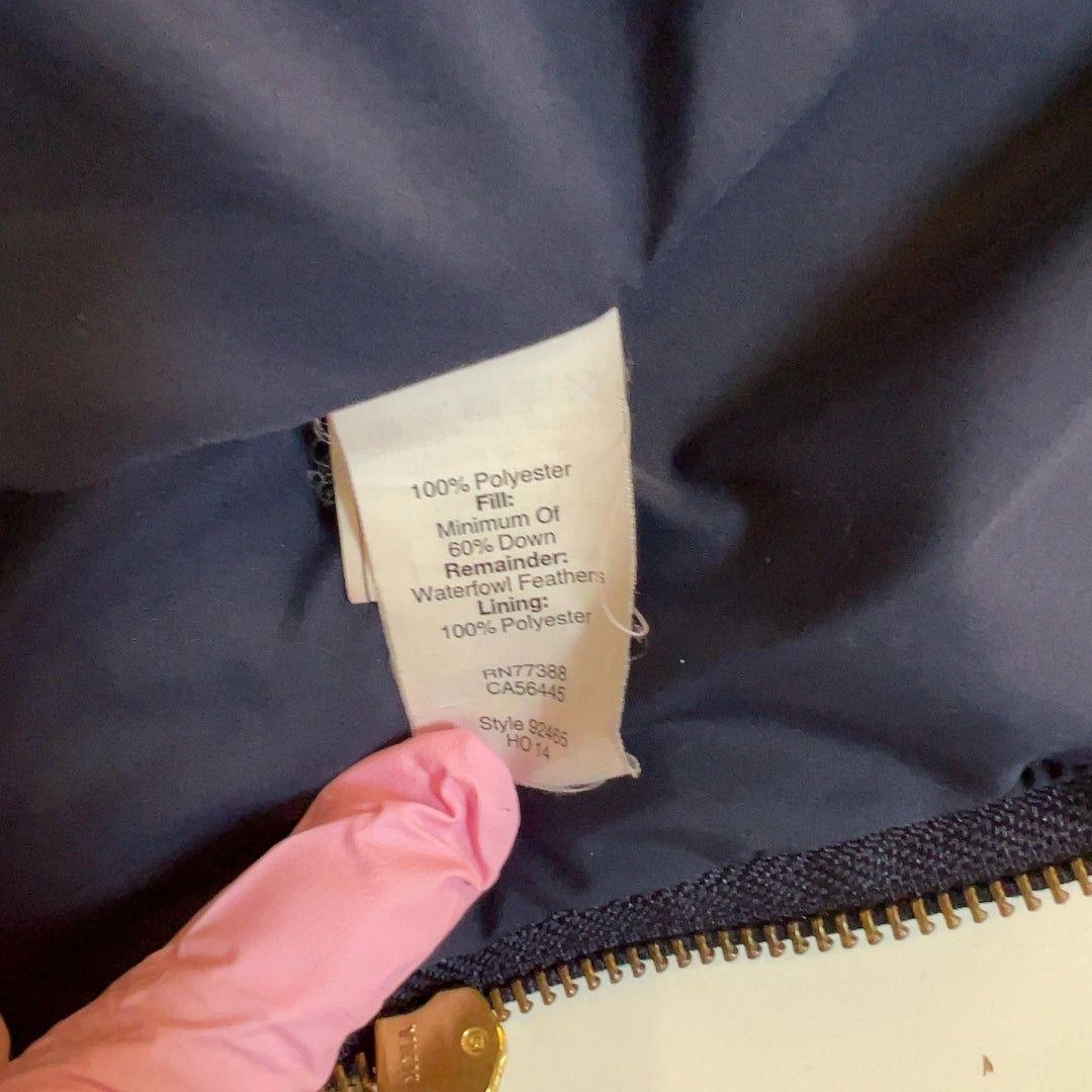 Navy quilted puffer vest with drawstring hem detail, tag vew