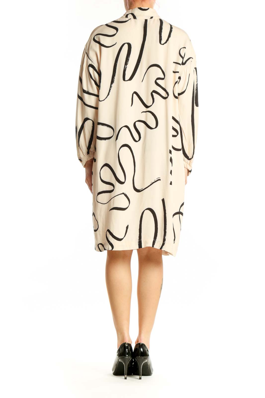 Back view of cream abstract line print shift dress showing relaxed silhouette and knee-length cut