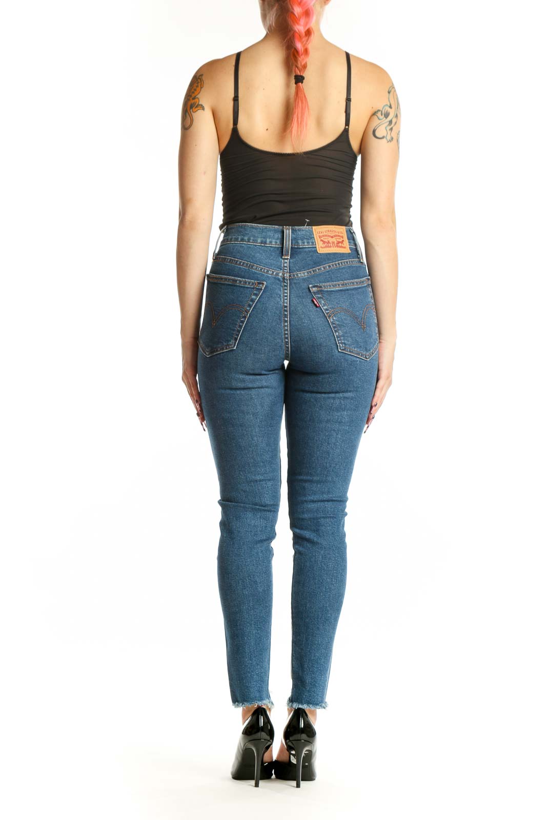 Back view of blue Levi's denim skinny jeans showing classic five-pocket styling and distressed ankle hem