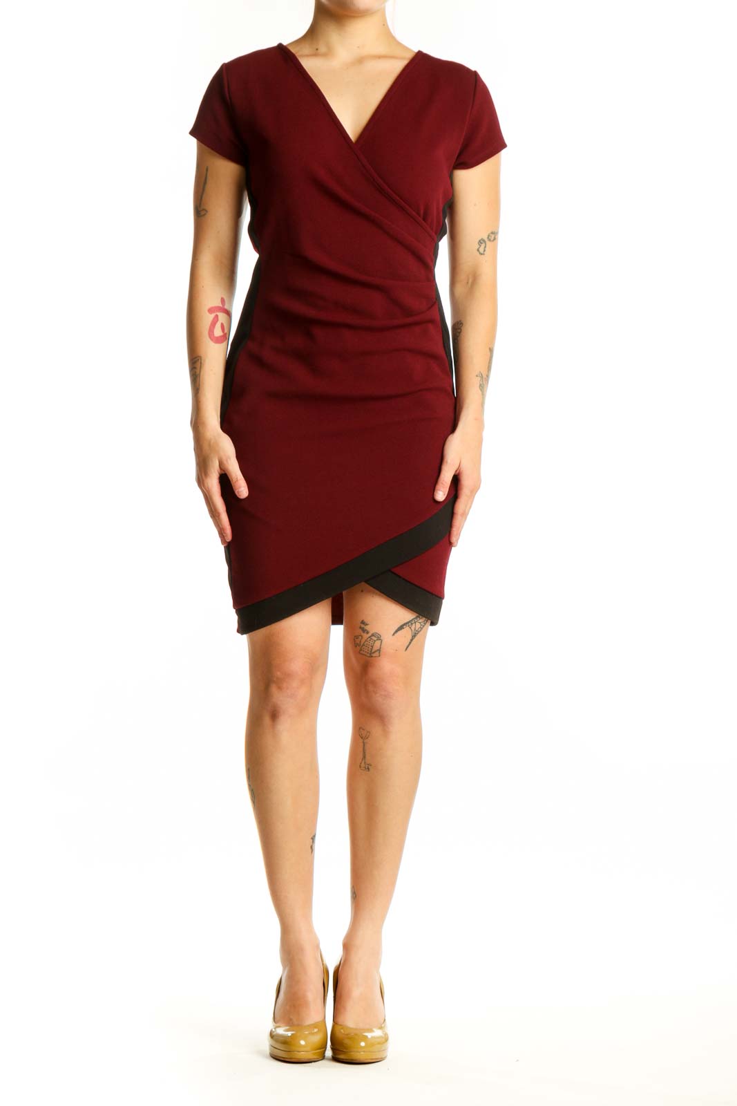 Burgundy wrap short sleeve dress with black asymmetrical trim and ruched bodice, front view