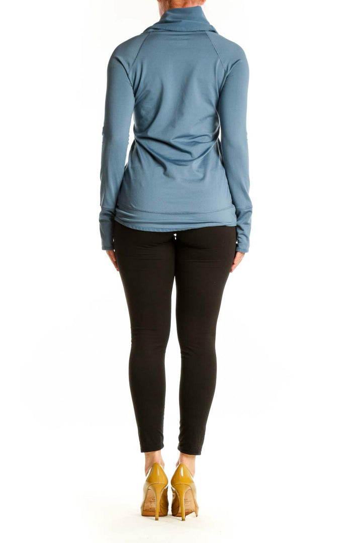 Blue cowl neck activewear top with long sleeves, back view on model