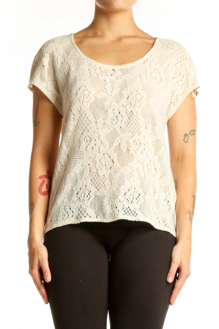 Cream lace short sleeve top with all-over lace pattern and rounded neckline, front view