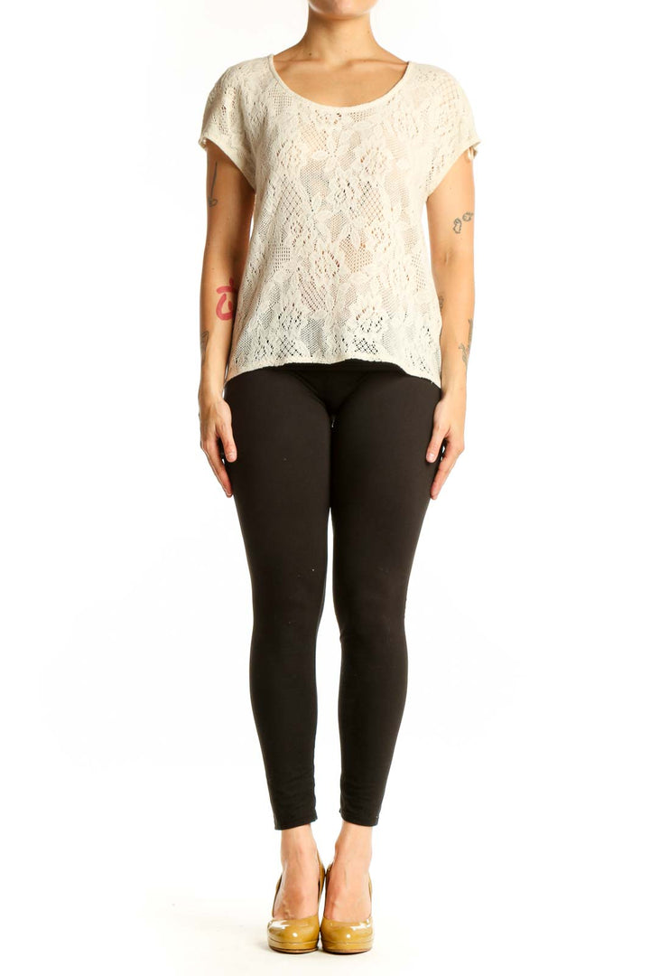 Cream lace short sleeve top with all-over lace pattern and rounded neckline, front view