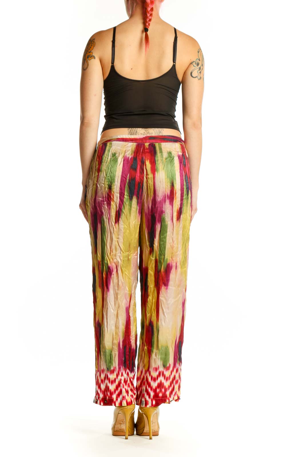 Back view of multicolor silk ikat print pants showing tapered silhouette and elastic waistband with tie detail