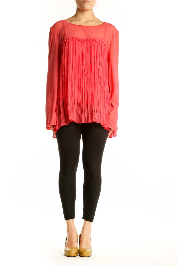 Red pleated long sleeve top with A-line silhouette and flowing pleated front detail