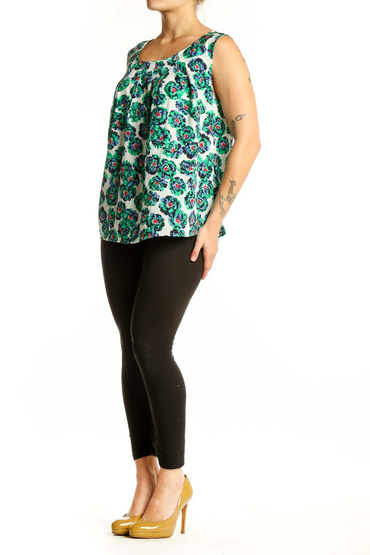 Cream sleeveless tank top with green and multicolor floral print, front view