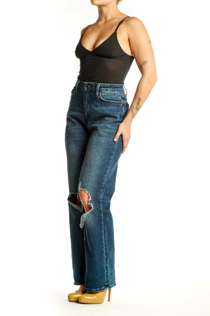 Front view of blue distressed knee rip denim jeans with medium wash and ripped detailing at knees
