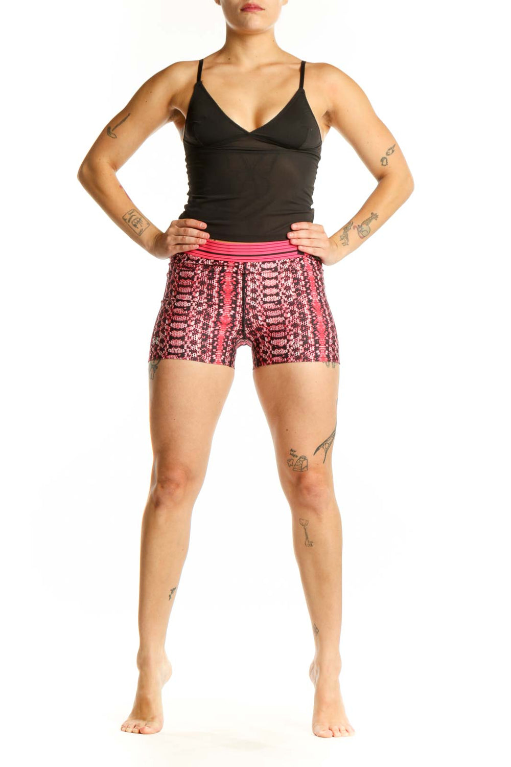 Front view of pink geometric print Under Armour athletic shorts with pink waistband on model