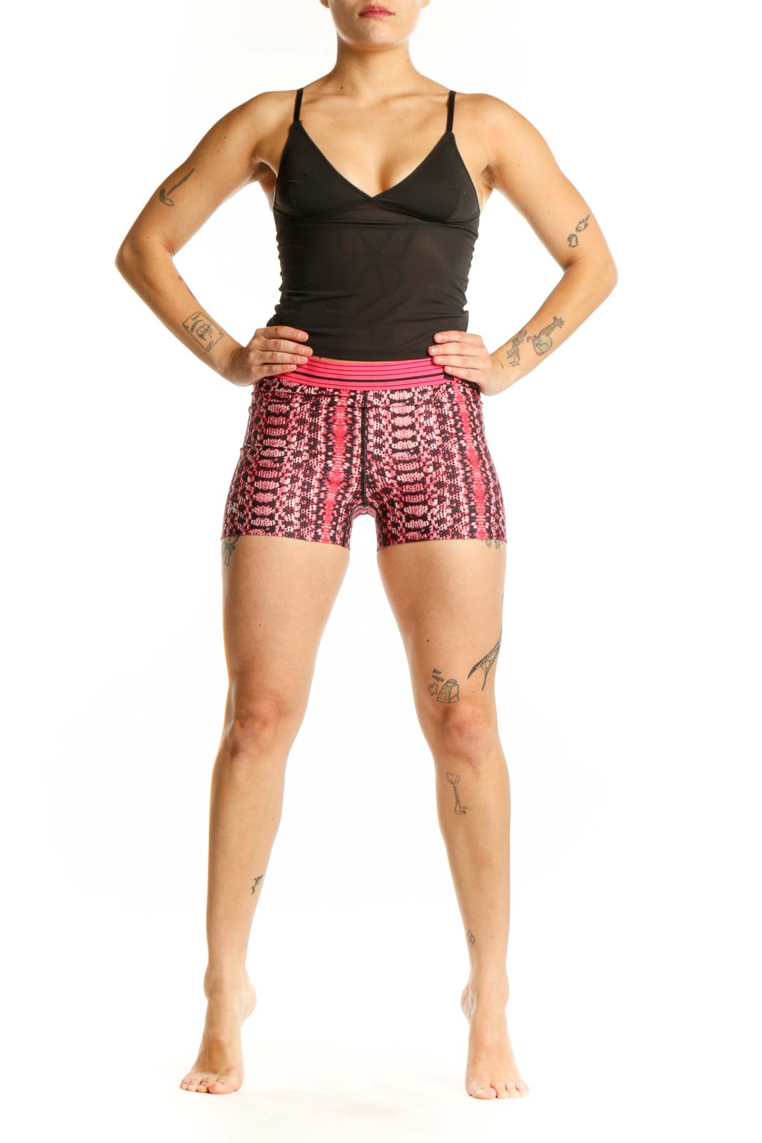 Front view of pink geometric print Under Armour athletic shorts with pink waistband on model