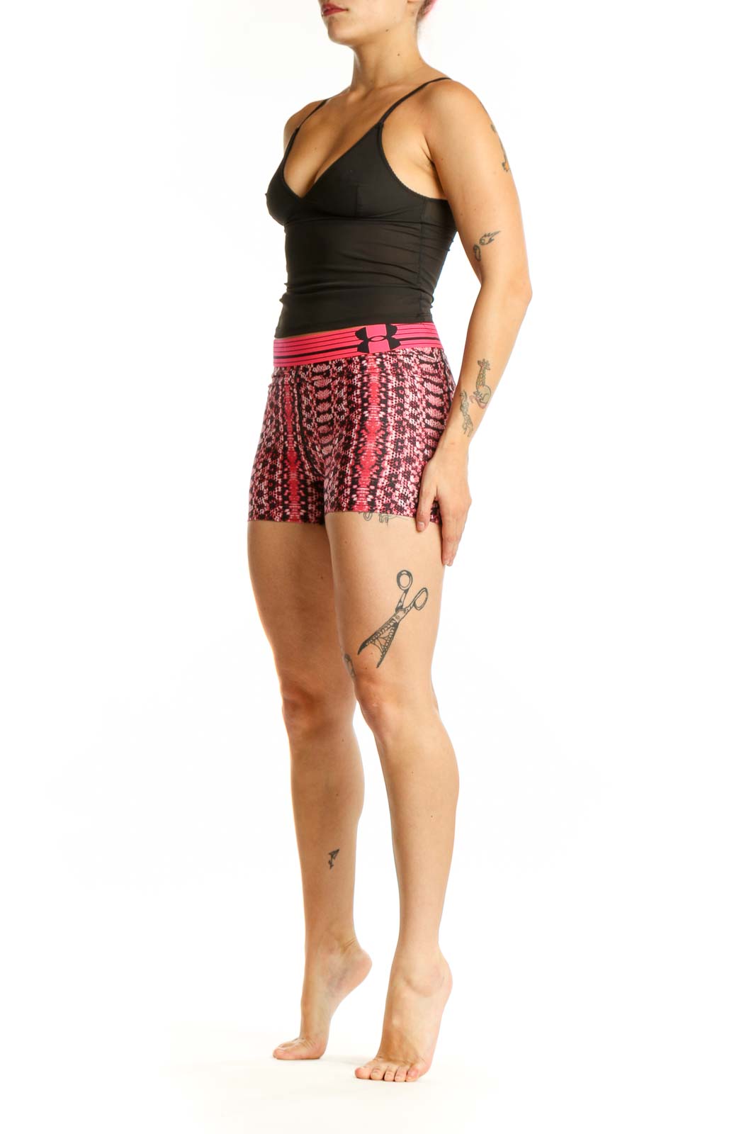 Front view of pink geometric print Under Armour athletic shorts with pink waistband on model