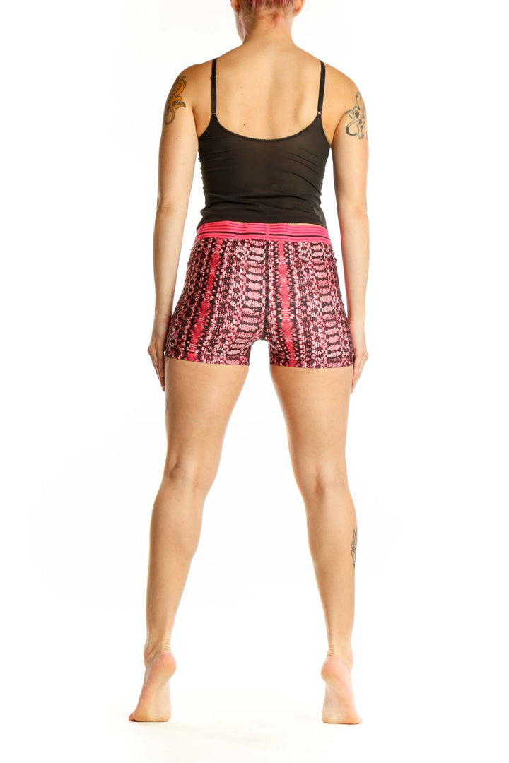 Back view of pink geometric print Under Armour athletic shorts showing jacquard pattern and fit