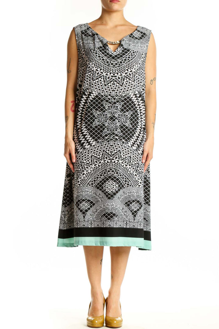 Black and white geometric print sleeveless midi dress with V-neckline and mint green hem, front view