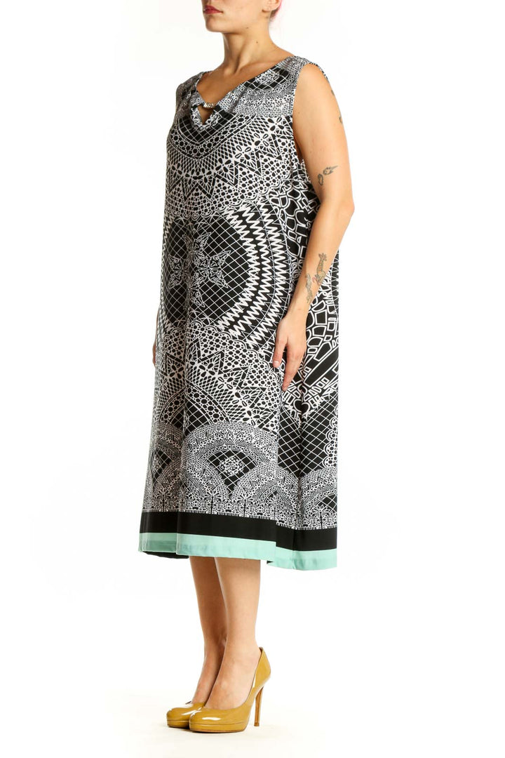 Black and white geometric print sleeveless midi dress with V-neckline and mint green hem, front view