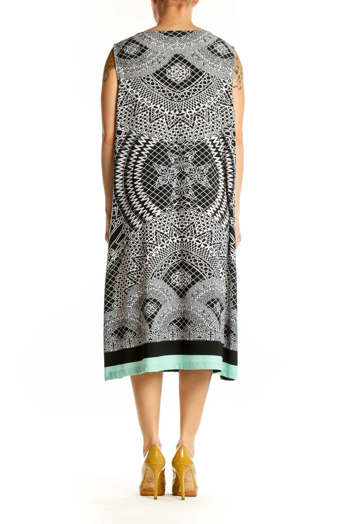 Black and white geometric print sleeveless midi dress with V-neckline and mint green hem, back view