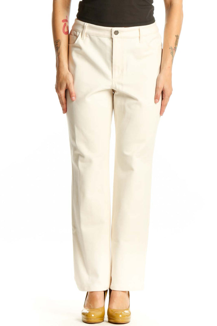 Front view of cream dress pants with straight-leg silhouette and high-waisted fit