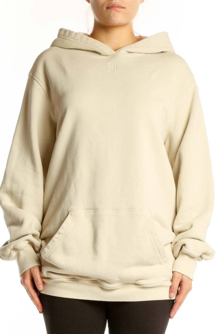 Woman wearing cream organic cotton hoodie with front pockets and relaxed fit by MB by Malene Birger