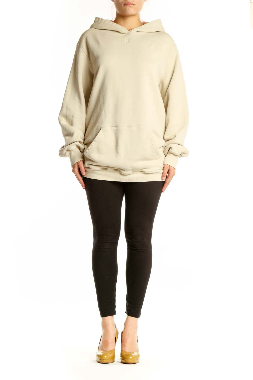 Woman wearing cream organic cotton hoodie with front pockets and relaxed fit by MB by Malene Birger