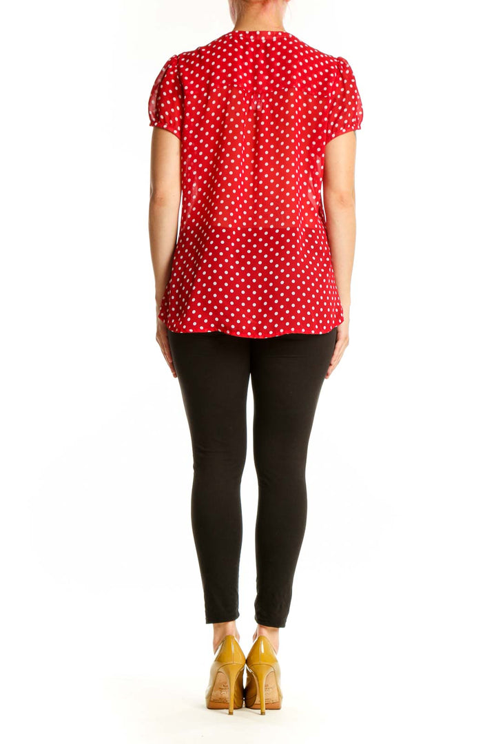 Back view of red polka dot blouse showing relaxed fit and short sleeve design