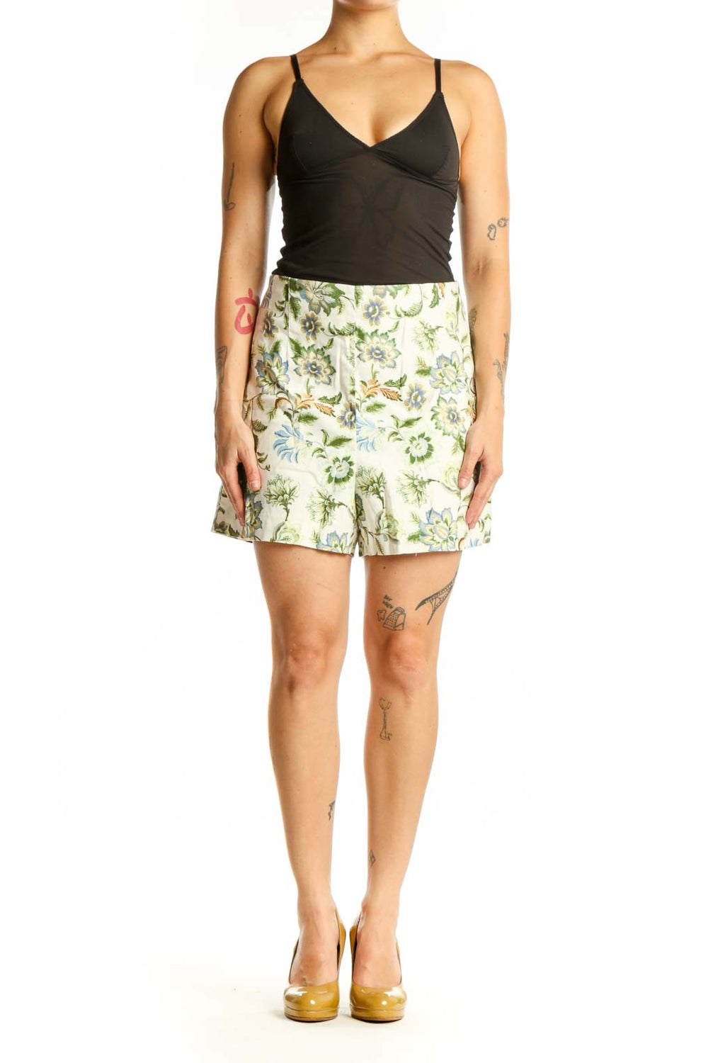 Front view of cream floral print LOFT shorts with green and blue botanical design, paired with black top