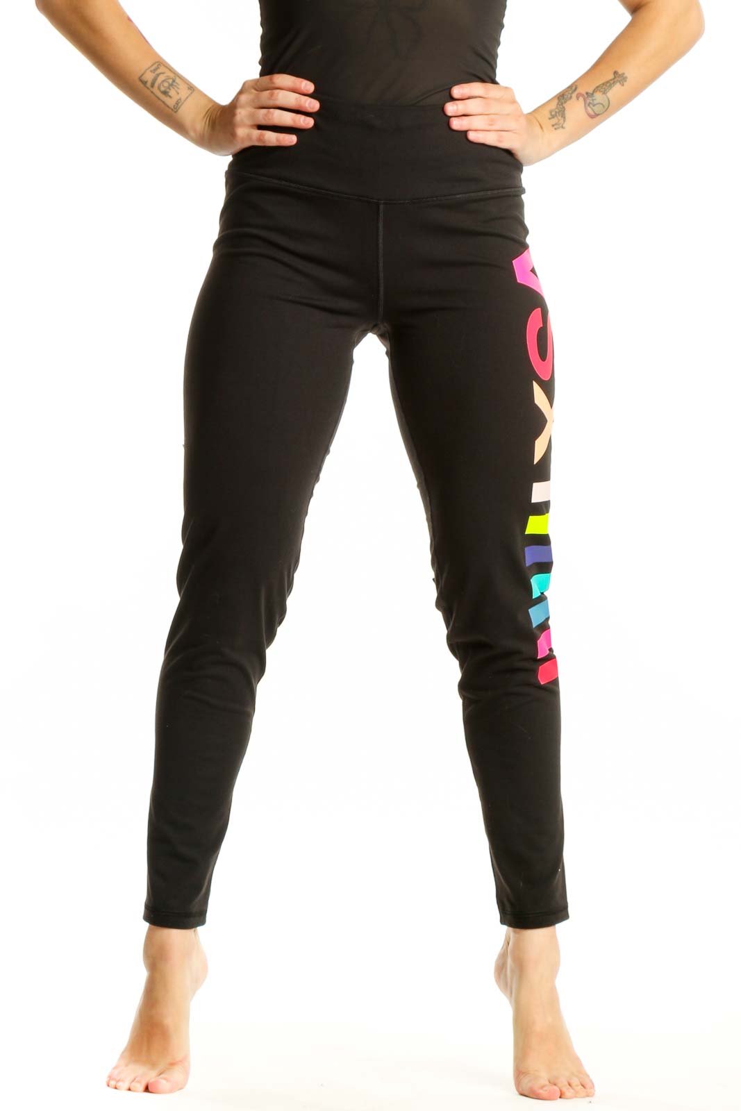 Black activewear leggings with neon pink, yellow, and blue colorblock stripes down the leg, front view