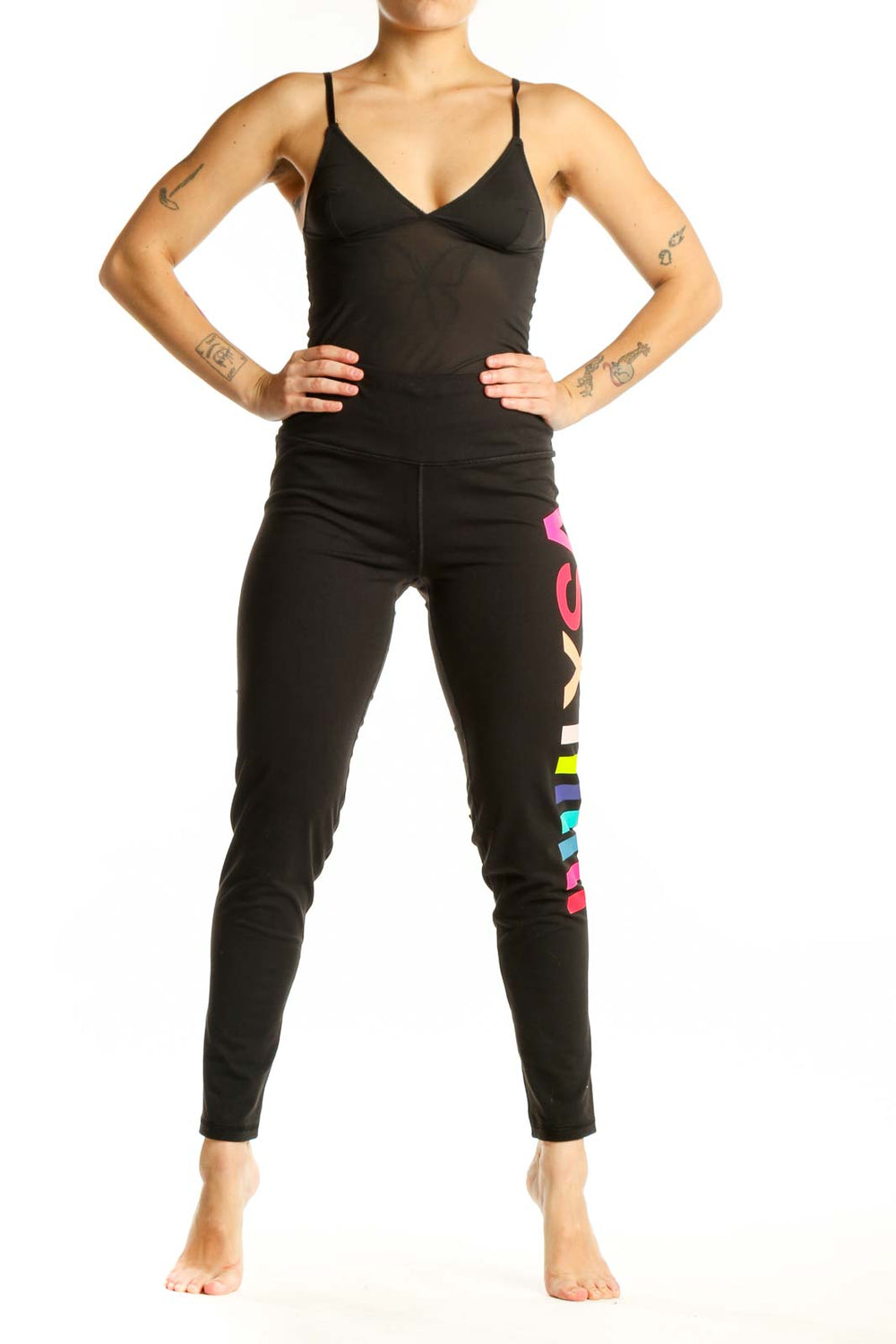 Black activewear leggings with neon pink, yellow, and blue colorblock stripes down the leg, front view