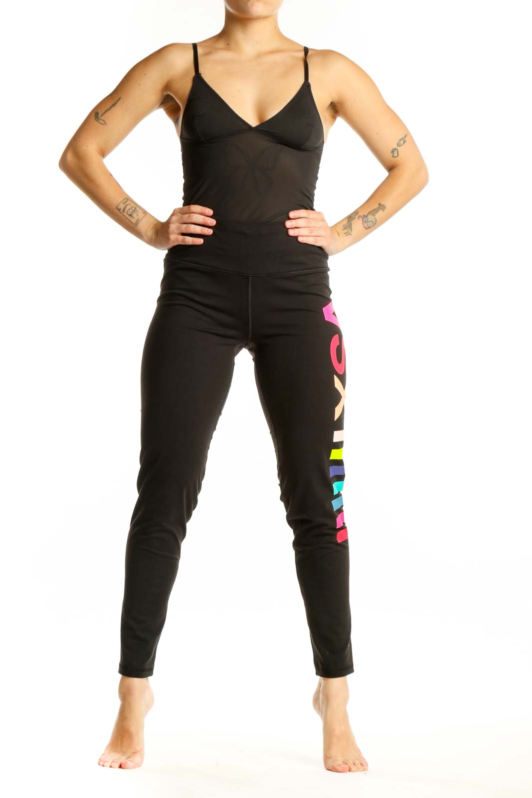 Black activewear leggings with neon pink, yellow, and blue colorblock stripes down the leg, front view