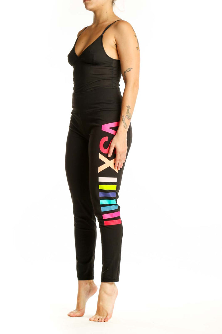 Black activewear leggings with neon pink, yellow, and blue colorblock stripes down the leg, front view