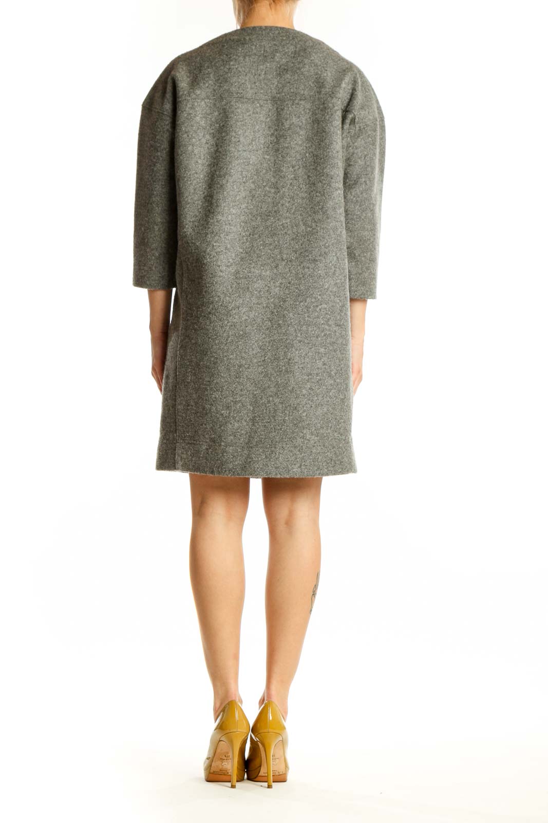 Back view of gray wool-blend shift dress showing relaxed silhouette and side pocket detail