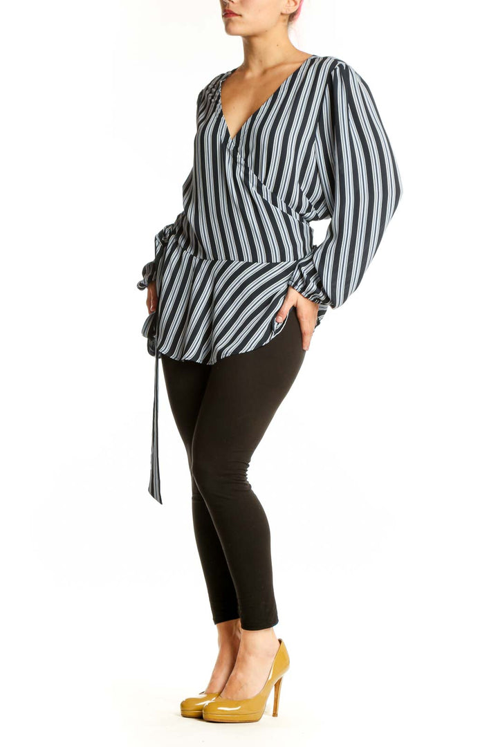 Navy and white striped wrap blouse with balloon sleeves, front view on model