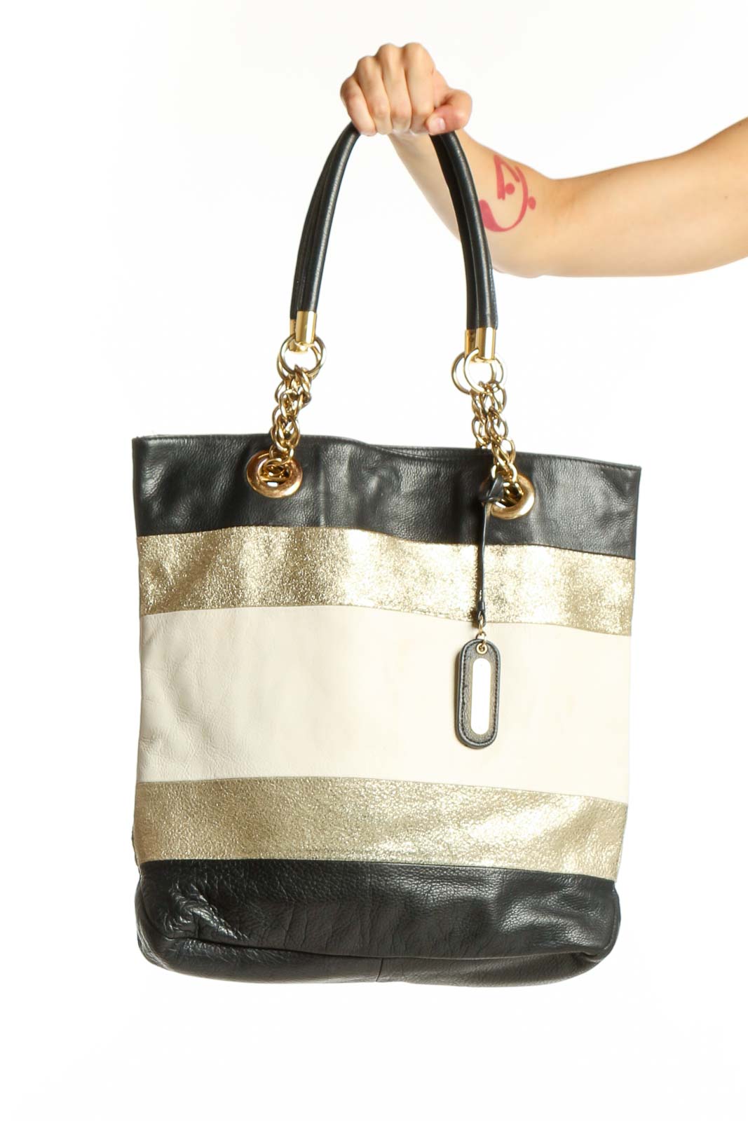 Black and gold striped genuine leather tote bag by Cynthia Rowley with dual handles and chain accents