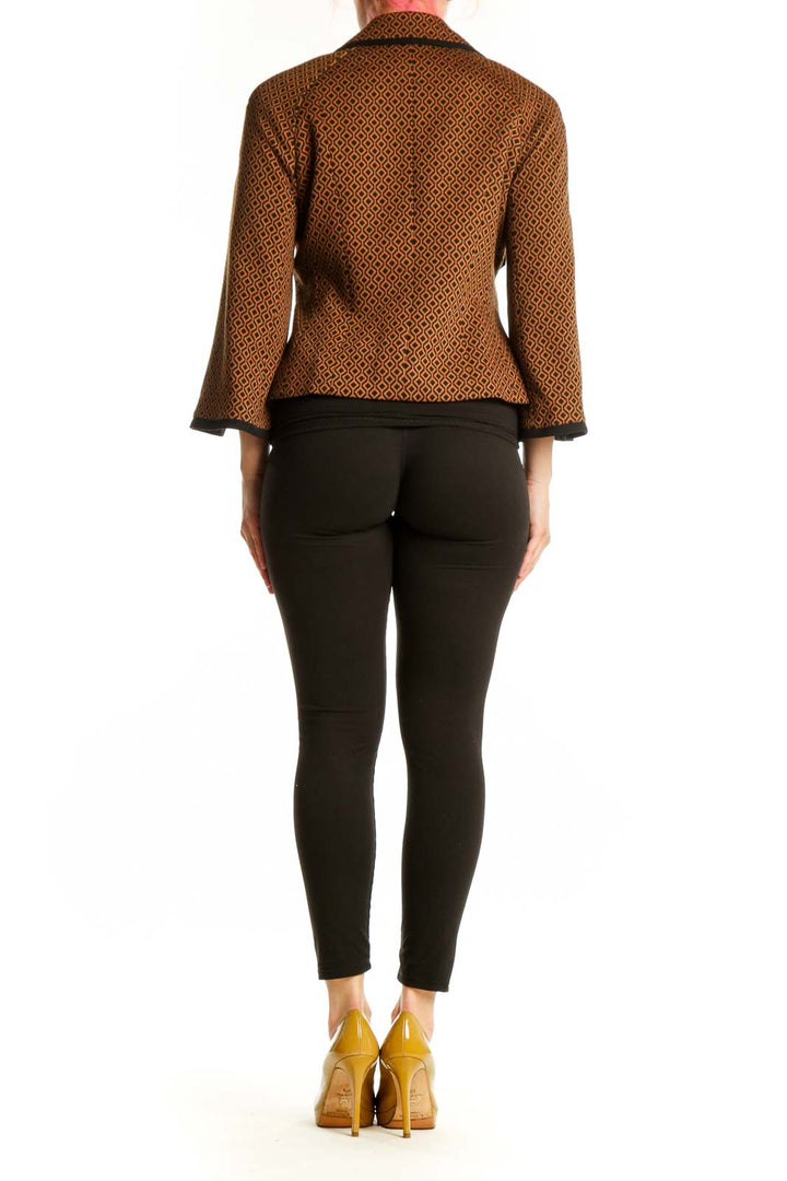 Brown geometric patterned Nine West blazer jacket with black trim, back view on model wearing black pants