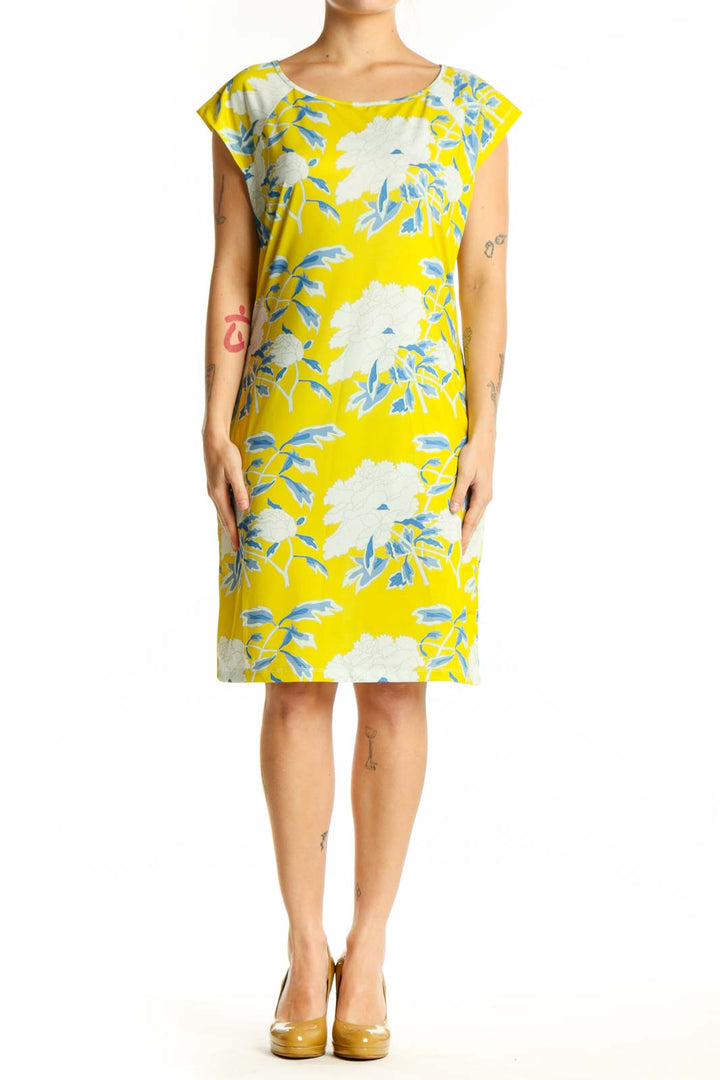 Front view of yellow floral print shift dress with blue and white botanical pattern, short sleeves, and crew neckline
