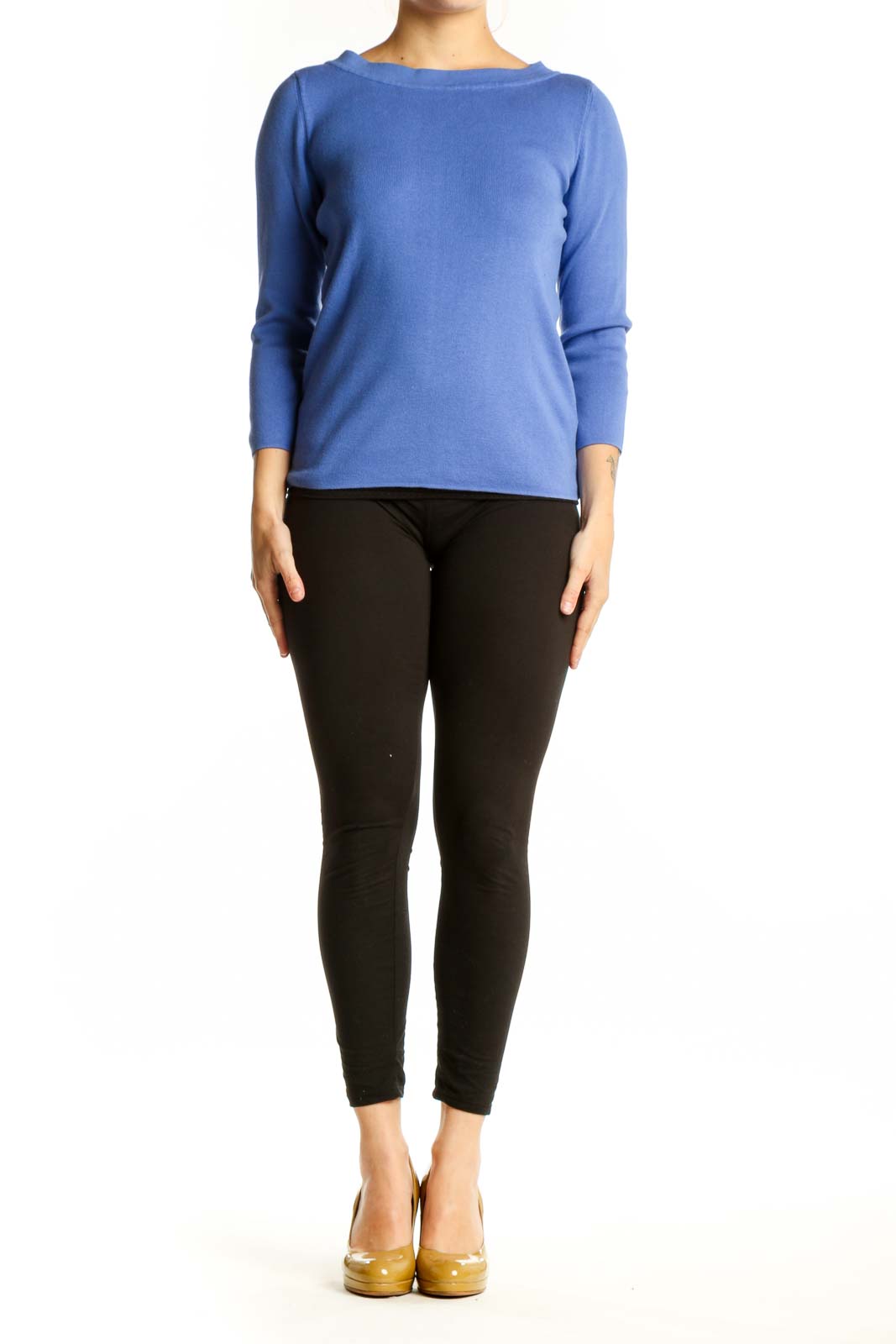 Blue crew neck top with three-quarter sleeves worn with black pants, front view