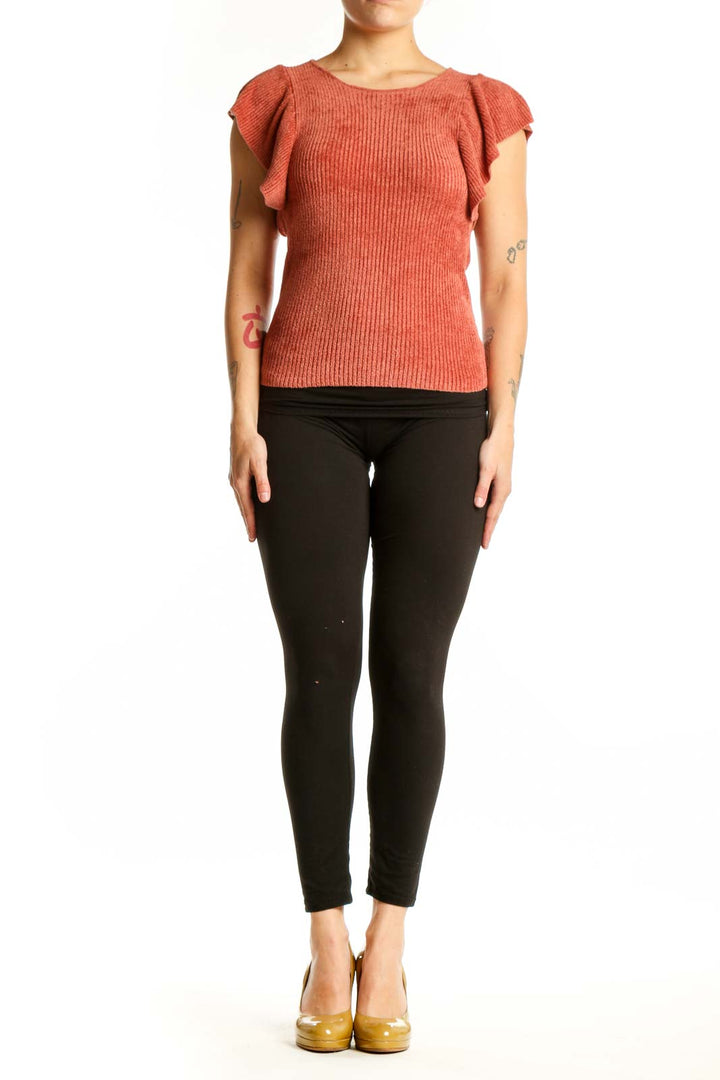 Rust orange ribbed top with ruffle cap sleeves and crew neckline, front view on model