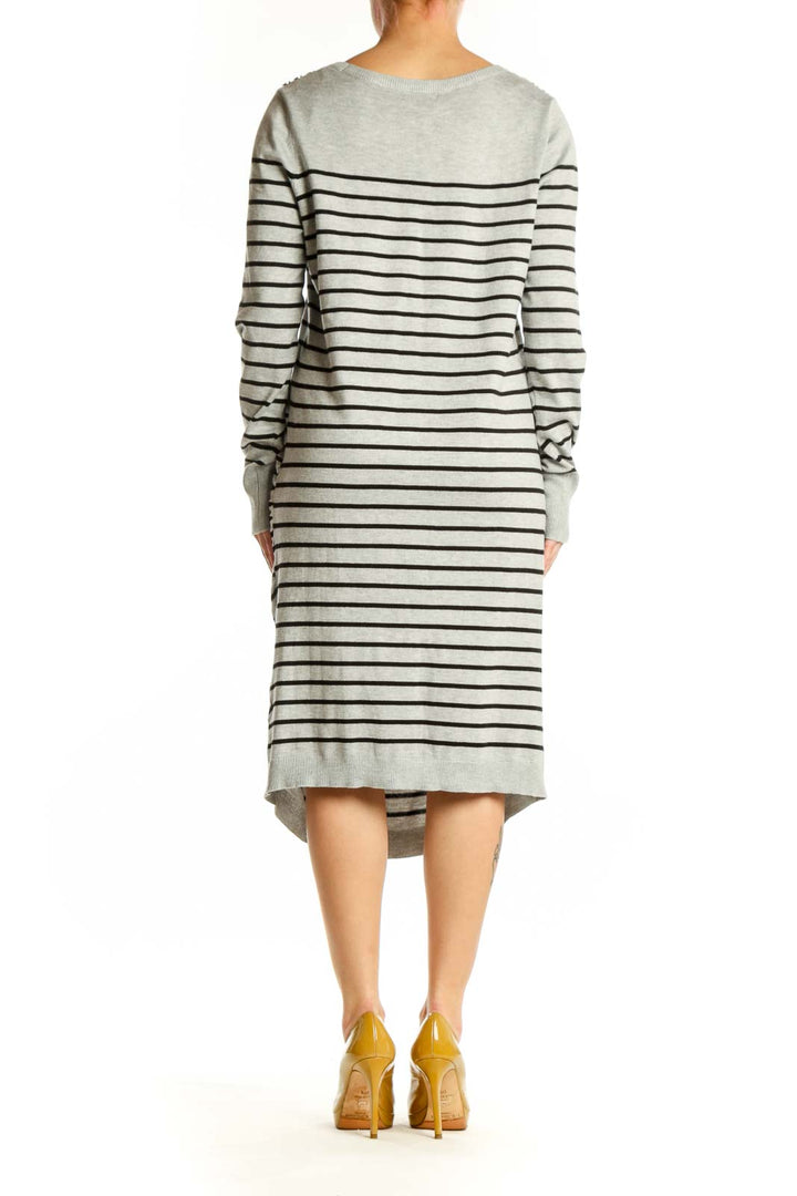Back view of gray and navy striped long sleeve knit dress showing curved seaming and relaxed silhouette